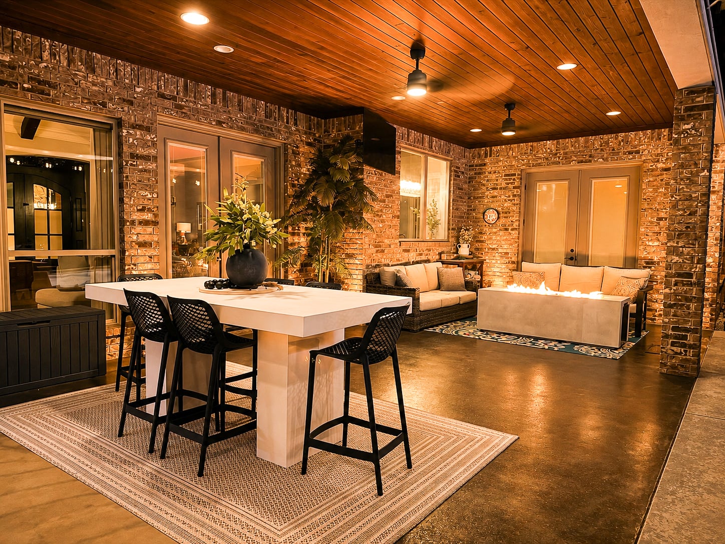 Custom outdoor kitchen and covered patio at twilight