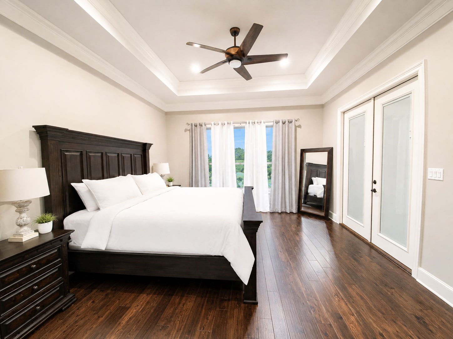 Primary bedroom with large windows and remote-controlled blinds